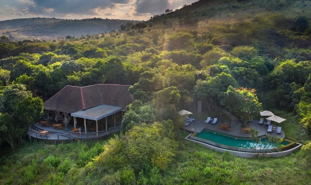 Luxury safari tented camp surrounded by green vegetation in Kenya
