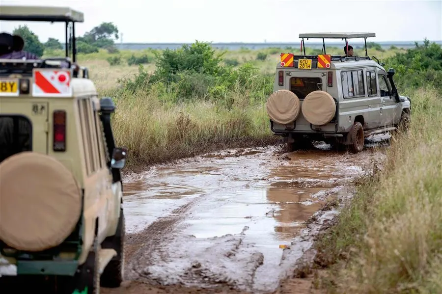4x4 Land Cruiser navigating a muddy safari track in Kenya during the rainy season
