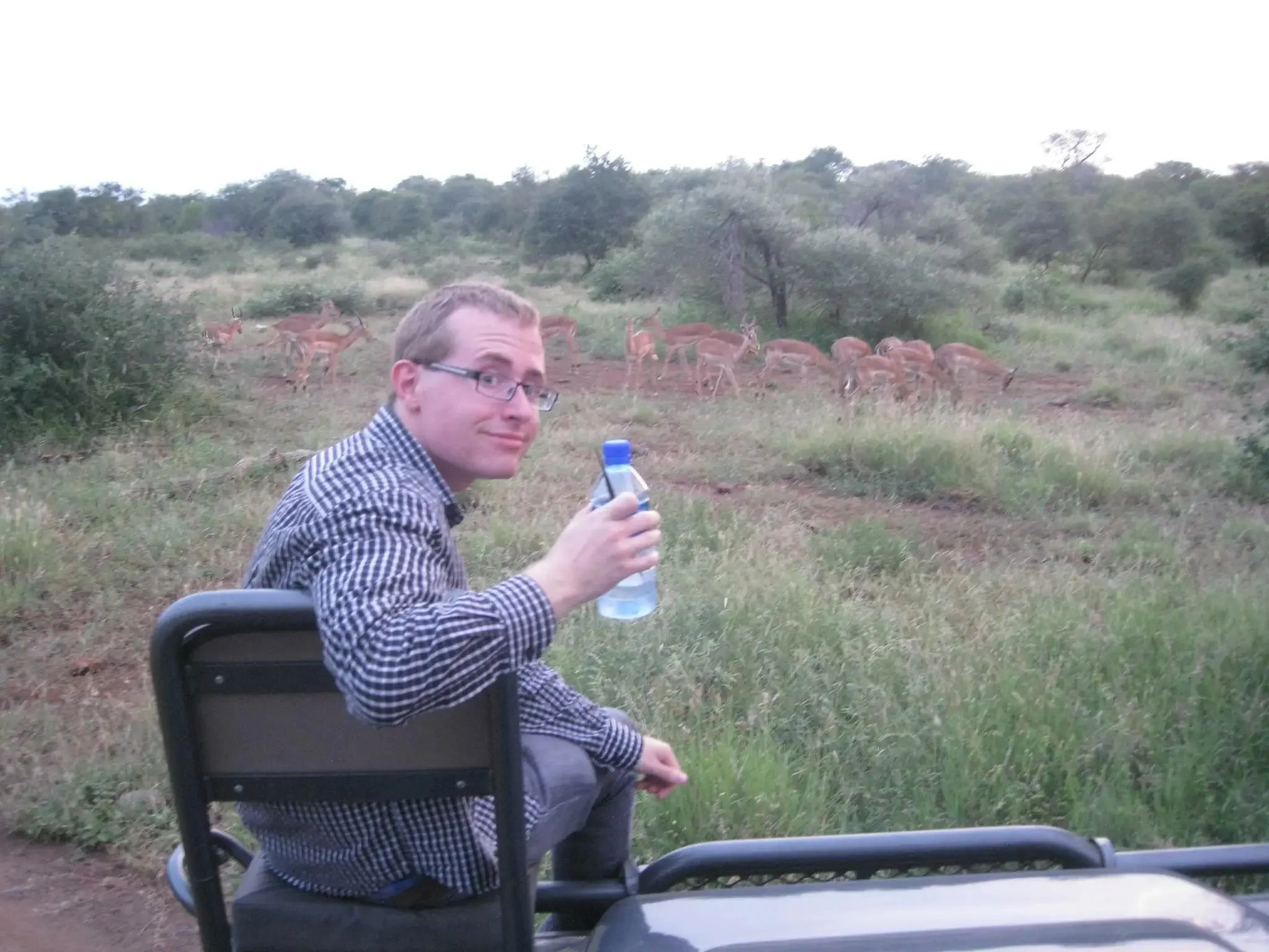 Traveller drinking sealed bottled water during a Kenya safari