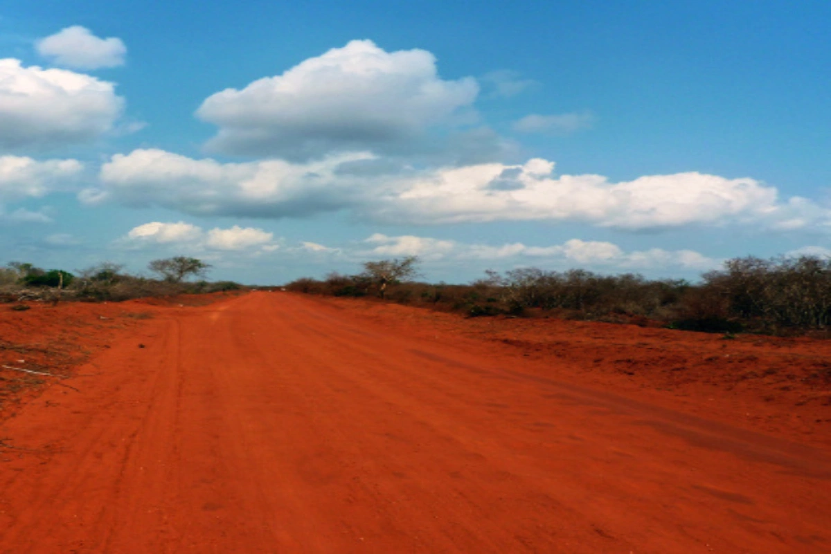 Close-up of iron-rich red volcanic soil displaying deep rust-colored earth in Tsavo National Park.