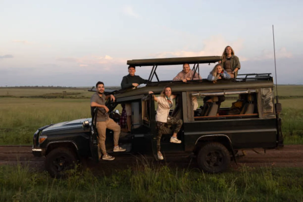 Shared 4x4 Land Cruiser safari vehicle with tourists on a group game drive in Kenya