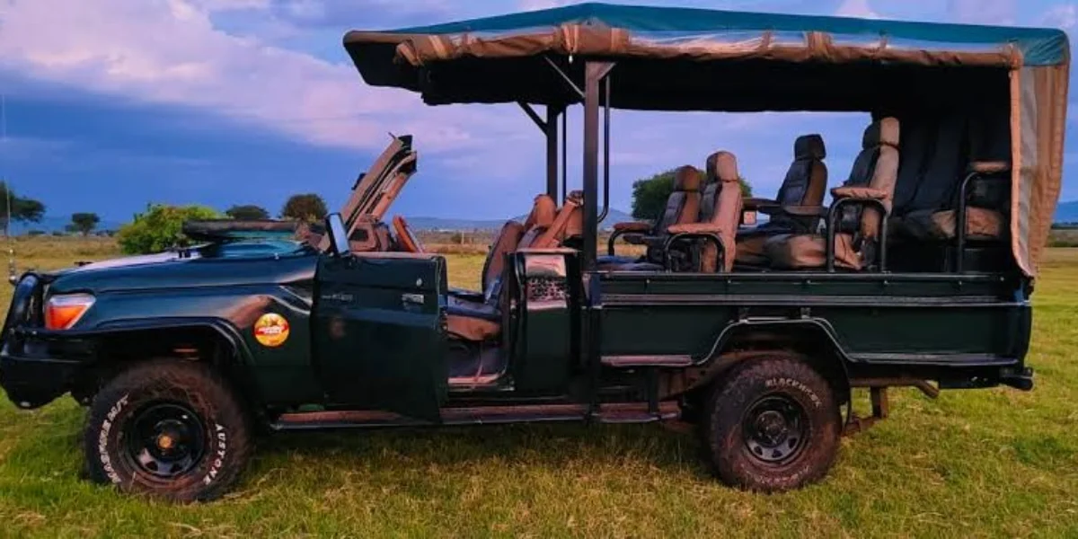 Open-sided customized 4x4 Land Cruiser safari vehicle designed with open shooting angles for wildlife photography in Kenya.
