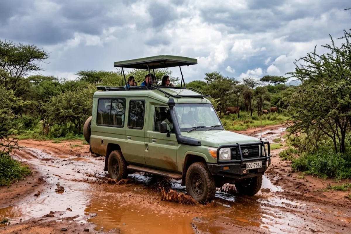 Custom 4x4 safari Land Cruiser navigating a wet murram road during short rains in Ol Pejeta Conservancy Laikipia Kenya.